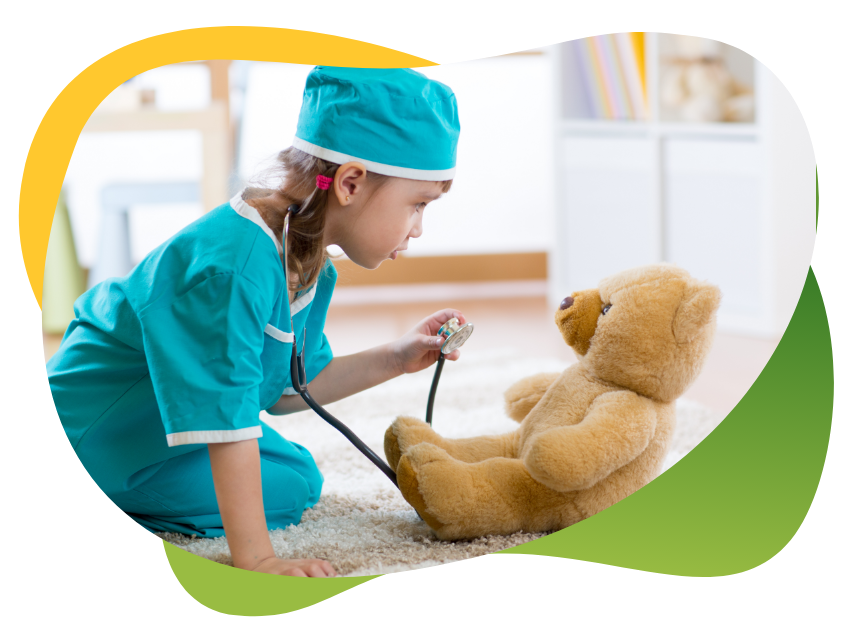 A child dressed up as a nurse and examining her teddy bear